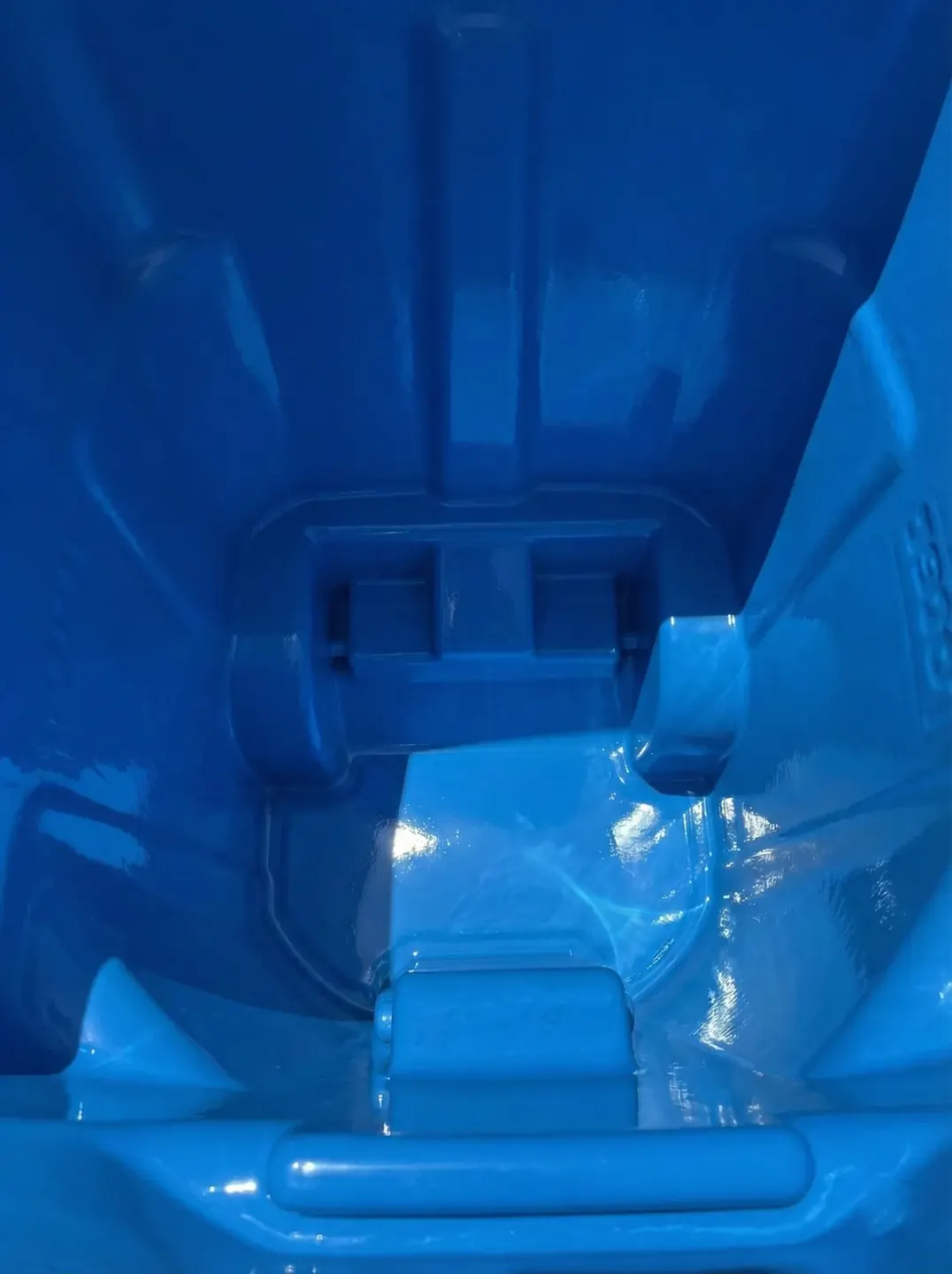 Gleaming blue bin interior after cleaning